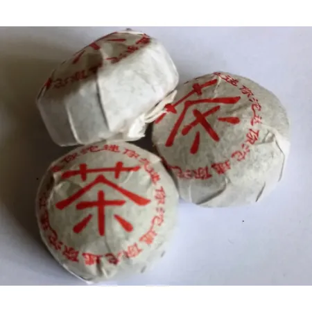 Prasowane gniazdka herbaty czerwonej Pu-erh Mini Tuocha zawinięte w papier ochronny – sklep dorotea.pl